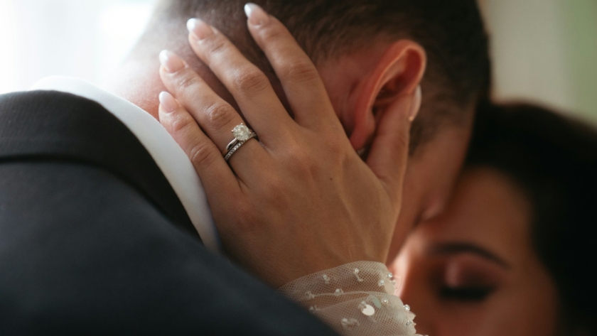 A couple shares an intimate, tender moment.